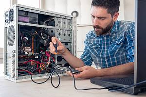FACTA compliant e-waste specialist working on computer 