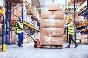 Warehouse workers moving boxes 